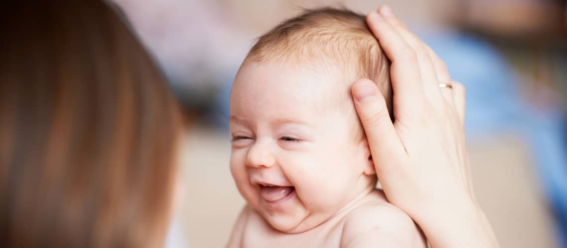 When does a baby hold its head up?