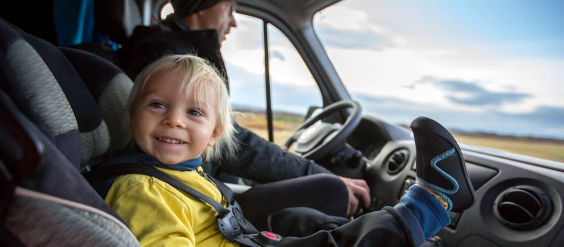 When can a child sit in the front of the car?