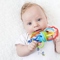 4-month-old baby with a toy