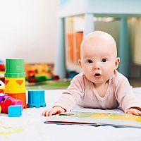 6-month-old baby with book